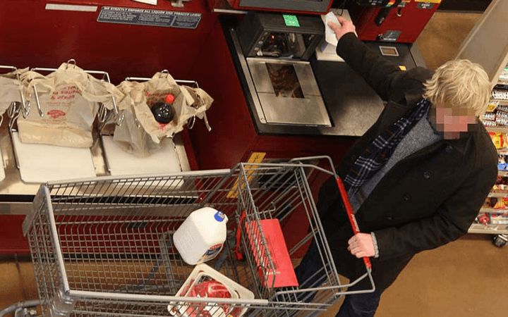 a-customer-is-caught-shoplifting-in-a-store-with-self-checkout-kiosks